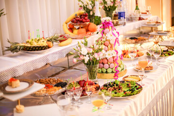 Beautiful table setting for wedding celebration in restaurant. Empty glasses and white napkins are installed in the restaurant on the table. Part of the interior. Elegant table set