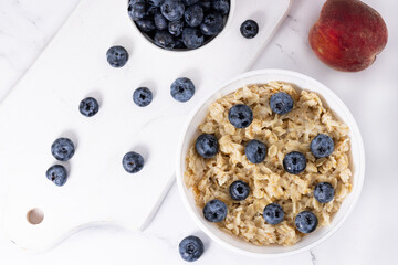 a bowl of oatmeal and blueberries. Healthy breakfastt op view.