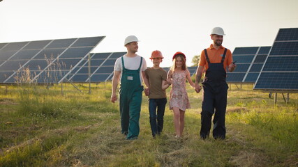 Two parents brought their children to work. Two employees of a solar power plant tell children...
