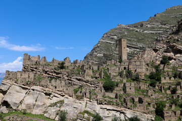 Fototapeta na wymiar ruins of the ancient village old Kahib in Dagestan, Russia with mountain on the background