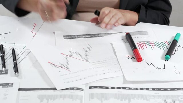 Woman investor at work analyzes the stock market.