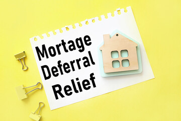 Mortgage Deferral Relief, text on white paper on yellow background. with a picture of a wooden house