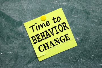 Time To Behavior Change. text on yellow sticker pinned to chalkboard