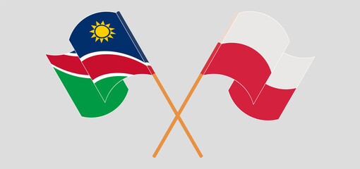 Crossed and waving flags of Namibia and Poland