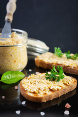 Delicious toasts with homemade chicken rillettes. Sandwich snack  with chicken pate on dark background