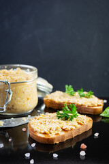 Delicious toasts with homemade chicken rillettes. Sandwich snack  with chicken pate on dark background