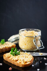 Delicious toasts with homemade chicken rillettes. Sandwich snack  with chicken pate on dark background