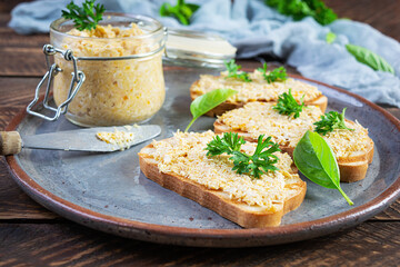 Delicious toasts with homemade chicken rillettes. Sandwich snack  with chicken pate on wooden...