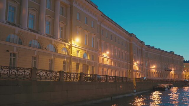 Saint-Petersburg, RUSSIA - May 29 2021, 4k: pleasure craft in Moyka river, view Hermitage museum, on May 29, 2021 in Saint-Petersburg, Russia