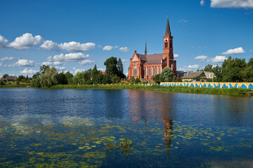 Old ancient church of St Anthony of Padua by river in Postavy, Vitebsk region, Belarus. - obrazy, fototapety, plakaty