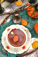 Autumn composition with a cup of tea in a vintage style.