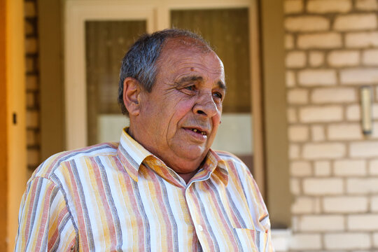 Portrait Of A Senior Man Outdoors. 70s Years Old Latin Or Hispanic Man Standing Outside In Summer Day. Casual And Lifestyle Concept