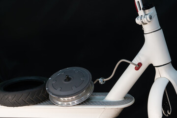 Repair of electric scooters. Electric motor and wheel close-up. Replacement of tires and tuby in the workshop.