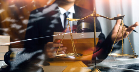 Business and lawyers discussing contract papers with brass scale on desk in office. Law, legal services, advice, justice and law concept picture with film grain effect