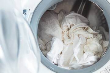 White clothes in washing machine. Open door
