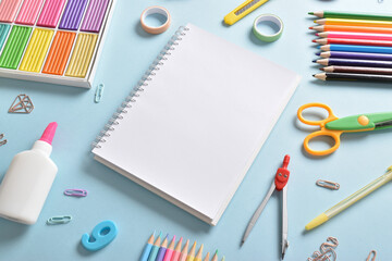 Stationery on a light blue background with space for text.