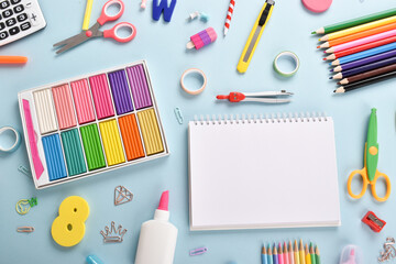 Stationery on a light blue background with space for text.