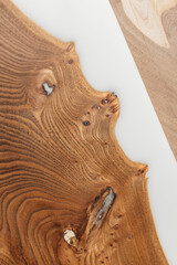 Exclusive handmade table of solid wood and epoxy resin on the background of wood boards