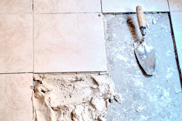 Home repairs. The worker's hands repair the broken floor