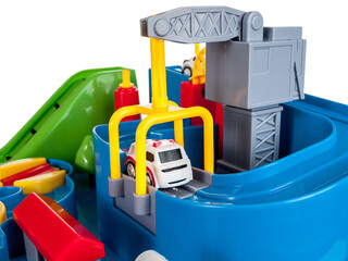 Game for children obstacle course with small cars, crane, slide, switch, close-up