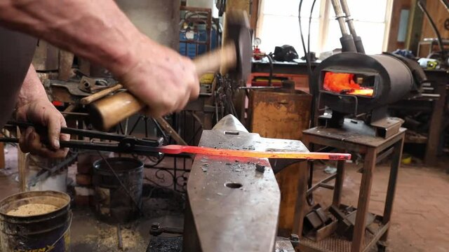 Blacksmith forging at the anvil