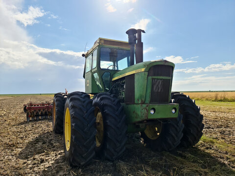 FLENSBURG, GERMANY - Aug 07, 2021: Big Green John Deere Tractor On A Field During Summer