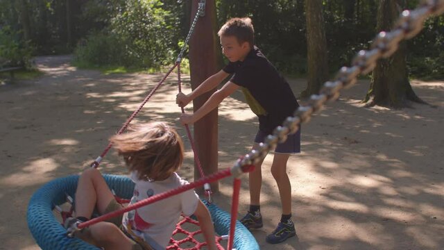Children are actively playing on the playground in the park. Bully boy showing noncompliant behavior problems. The emotional highs and lows that are part of symptoms borderline personality disorder. 