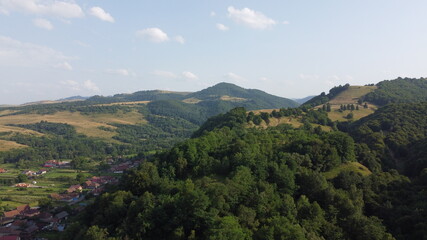 Panorama with hills, forest and village.