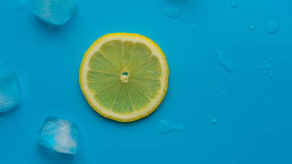 Creative summer background composition with lemon slice and ice cubes. Minimal concept of lemonade drink from top to bottom. Copy Spase.