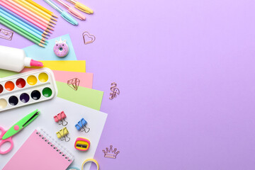 Stationery on a purple background with a place for text.