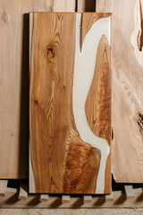 table of solid wood and epoxy resin on the background of wood boards