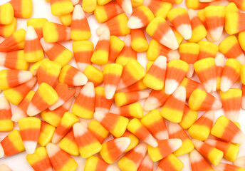 Candy corn in jar on white background