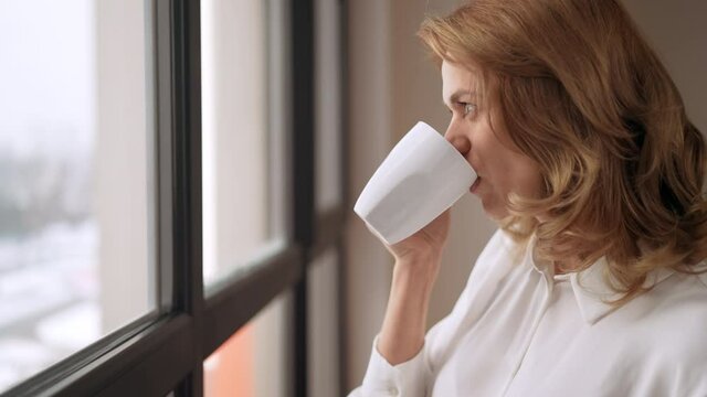 successful businesswoman holding cup