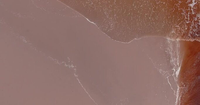 Aerial Looking Down on Clear and Rust Colored Water on Beach, Pringle Bay, South Africa
