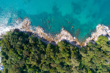 Amazing Sea aerial view Top down seashore nature background Beautiful Tropical beach with rocky mountains and turquoise clear water of Phuket Thailand ocean at sunny summer day Landscape background.