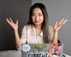 Young Edgy Asian Female Data Scientist Explaining The Scope of a Marketing Analytics Results