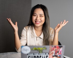 Young Edgy Asian Female Data Scientist Explaining The Scope of a Marketing Analytics Results