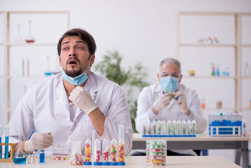Two male chemists in drugs synthesis concept at the lab