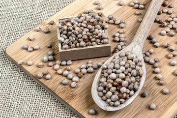 pigeon pea or tuvar beans or guandu bean (Cajanus cajan) seeds in transparent glass bowl and spoon on the wooden table in Brazil