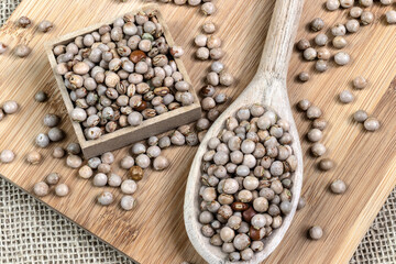 pigeon pea or tuvar beans or guandu bean (Cajanus cajan) seeds in ceramic bowl on the wooden table in Brazil