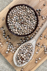 pigeon pea or tuvar beans or guandu bean (Cajanus cajan) seeds in ceramic bowl and spoon on the wooden table in Brazil