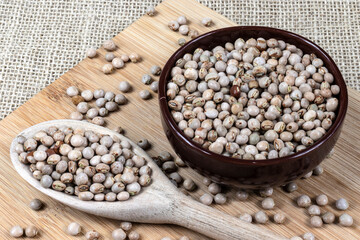 pigeon pea or tuvar beans or guandu bean (Cajanus cajan) seeds in ceramic bowl and spoon on the wooden table in Brazil