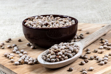 pigeon pea or tuvar beans or guandu bean (Cajanus cajan) seeds in ceramic bowl and spoon on the wooden table in Brazil