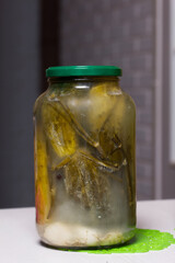 Pickled cucumbers in jars. Seasonal preservation of vegetables. Close-up shot.