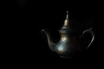 teapot on black background
