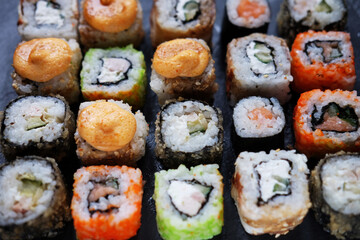 Japanese food. Sushi. Philadelphia roll with fresh salmon, cucumber, avocado, cream cheese, tobiko caviar.
