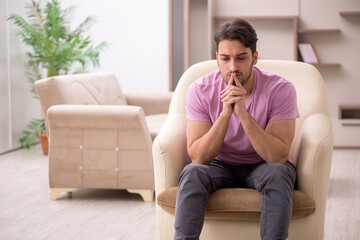 Young man siiting at home during pandemic