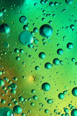 oil bubbles with water on glass
