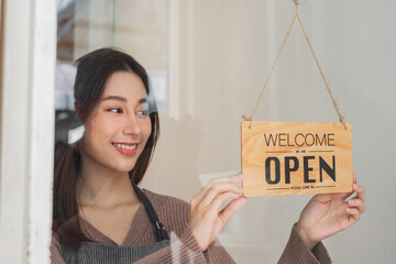 Smiling asian young business owner, employee retail,coffee shop woman,girl turning,setting sign...