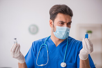 Young male doctor in vaccination concept during pandemic